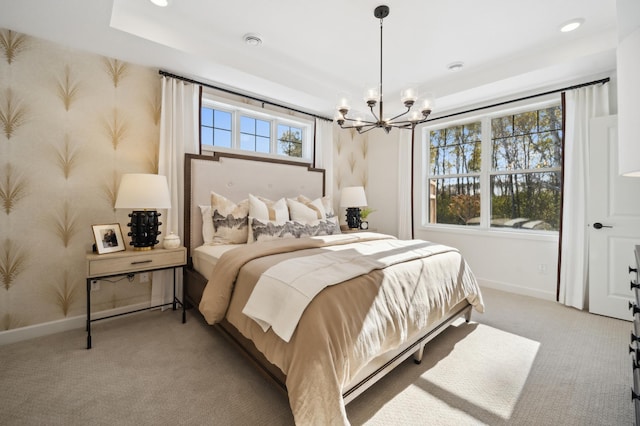 carpeted bedroom with multiple windows and a chandelier