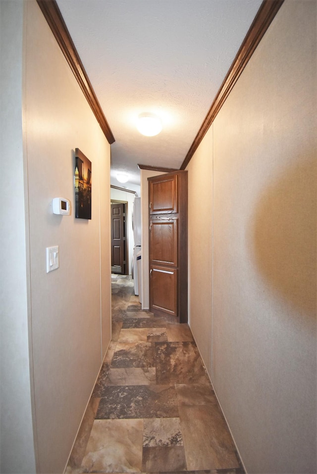 corridor with ornamental molding and dark tile floors