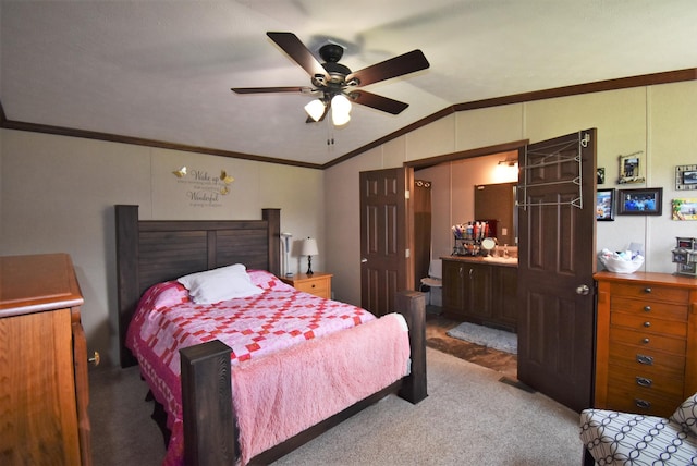 carpeted bedroom with ornamental molding, lofted ceiling, ceiling fan, and connected bathroom