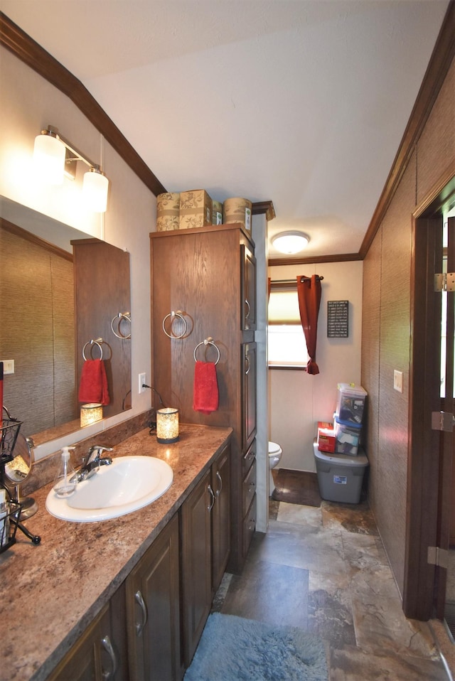 bathroom with ornamental molding, toilet, and vanity