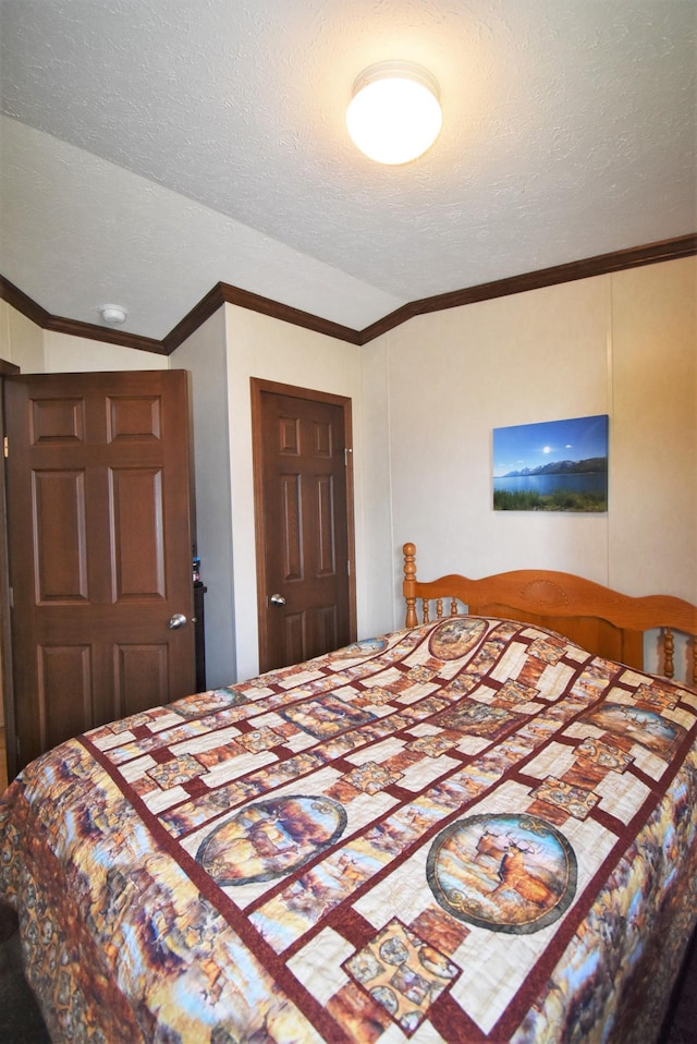 bedroom featuring lofted ceiling and a textured ceiling