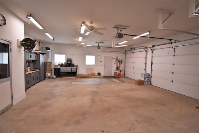 garage with ceiling fan and a garage door opener