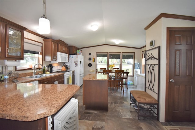 kitchen with dark tile floors, decorative light fixtures, white appliances, sink, and a kitchen island