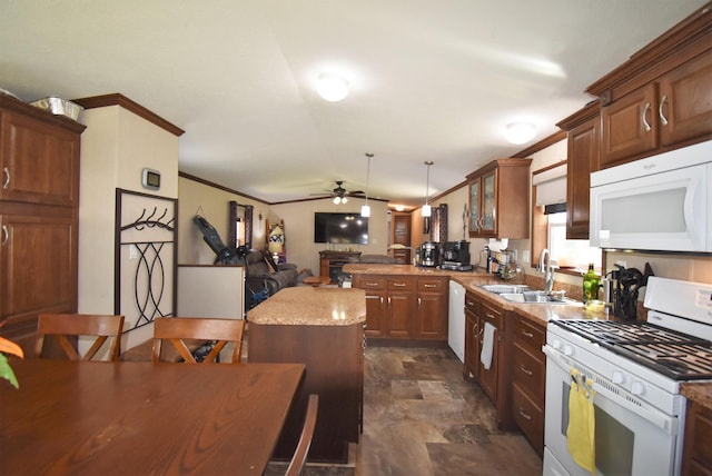 kitchen with ceiling fan, sink, white appliances, dark tile flooring, and decorative light fixtures