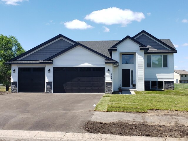 view of front of property with a garage and a front yard