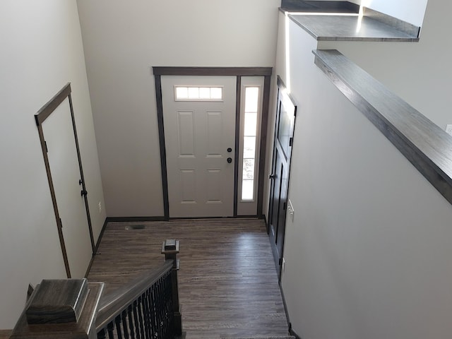 entrance foyer with plenty of natural light and dark hardwood / wood-style floors