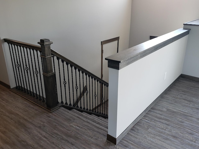 staircase featuring dark hardwood / wood-style floors