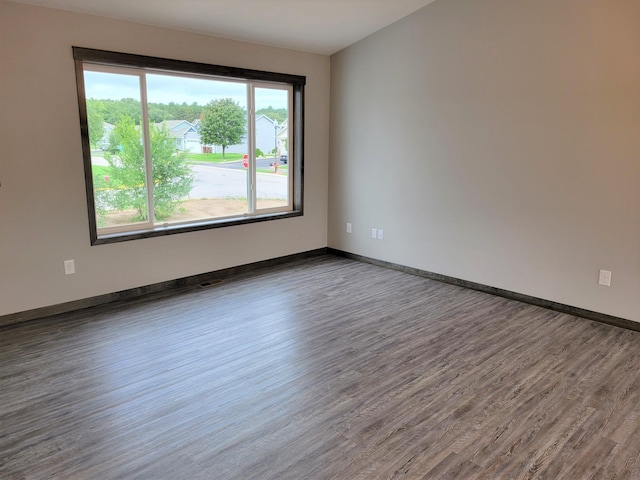 unfurnished room featuring dark hardwood / wood-style flooring