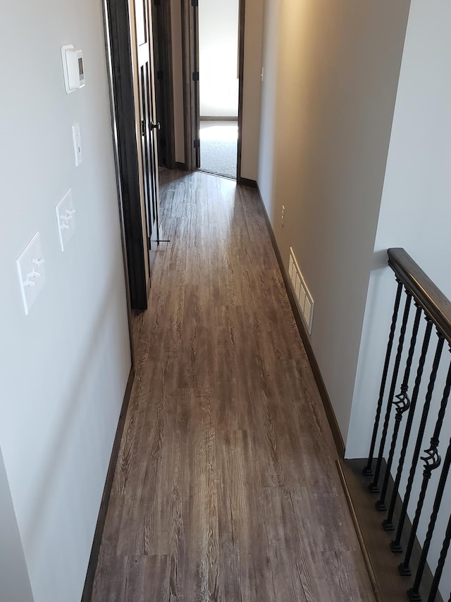 hallway featuring dark hardwood / wood-style flooring