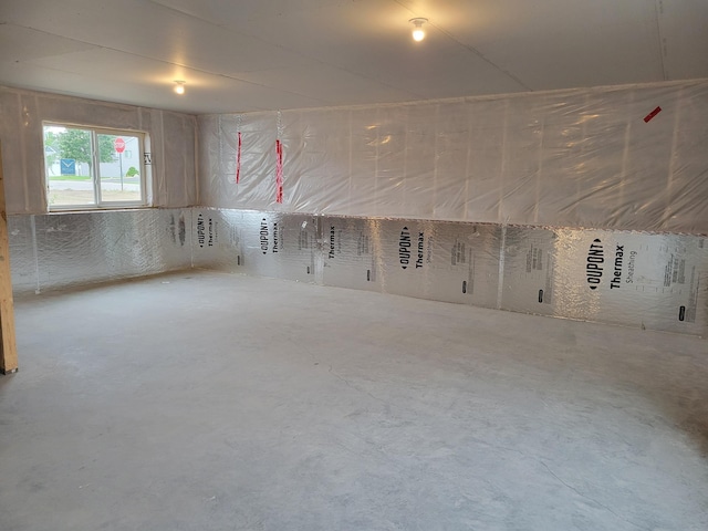 unfurnished room with concrete flooring