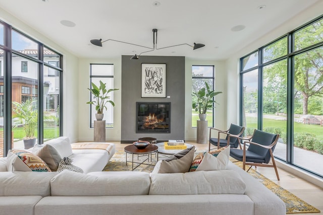 sunroom featuring a fireplace and a healthy amount of sunlight