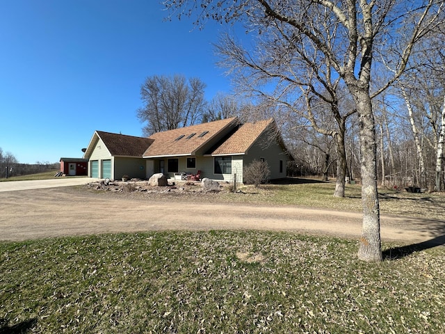 view of front of home with a garage and a front lawn