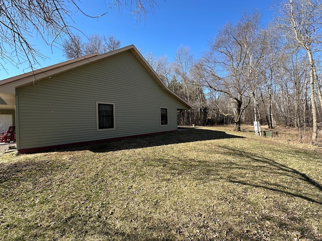 view of side of home with a lawn