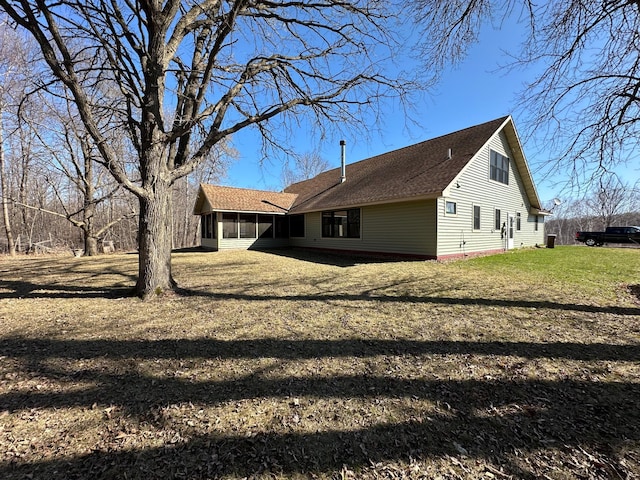 back of property with a lawn