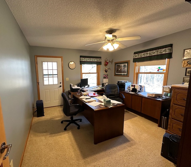 office with light colored carpet, ceiling fan, and a textured ceiling