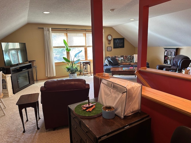 carpeted living room featuring lofted ceiling and a textured ceiling