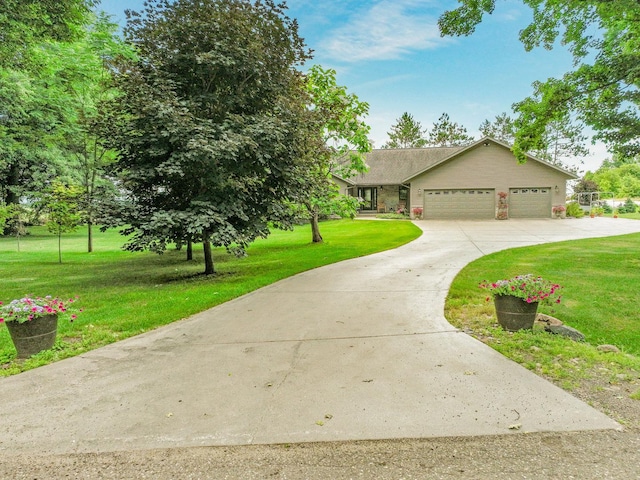 view of front of property with a garage and a front lawn