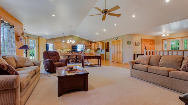 carpeted living room with ceiling fan with notable chandelier and vaulted ceiling