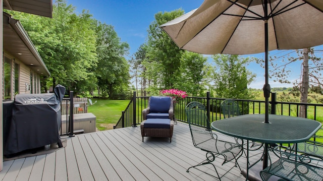 wooden terrace with a grill and a lawn