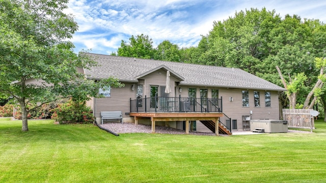 W9495 Springwood Ln, Withee Twp, WI 54771 - rear view of house featuring a hot tub, stairs, a deck, and a lawn