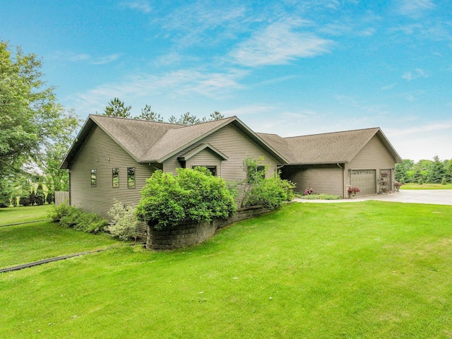 W9495 Springwood Ln, Withee Twp, WI 54771 - view of front of home featuring concrete driveway, an attached garage, and a front yard