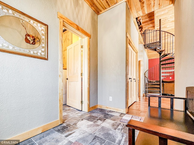 hallway with baseboards and a textured wall