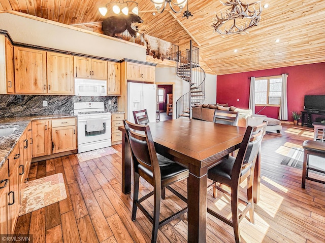 dining area with vaulted ceiling, wood ceiling, stairway, and hardwood / wood-style floors