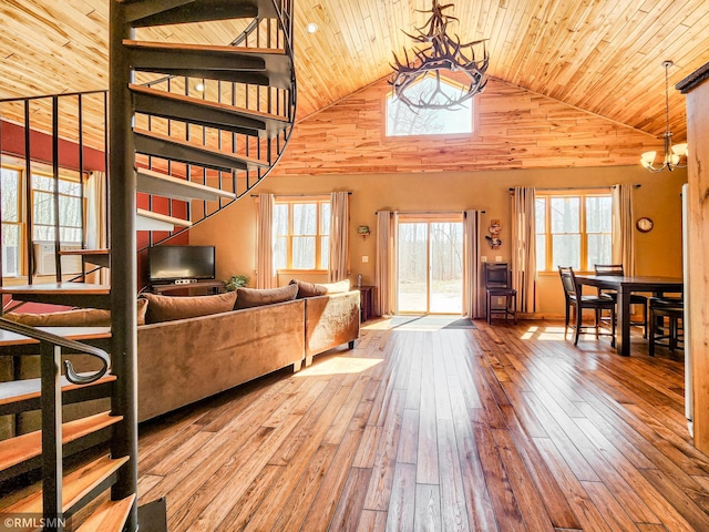 living area featuring an inviting chandelier, wooden ceiling, wood-type flooring, and high vaulted ceiling
