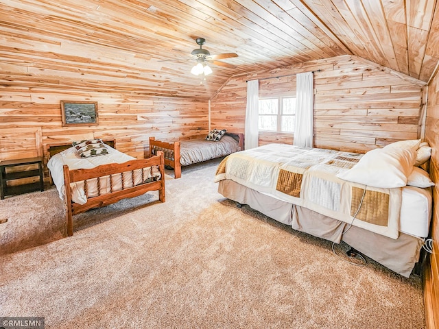 bedroom with wood walls, vaulted ceiling, ceiling fan, carpet floors, and wood ceiling