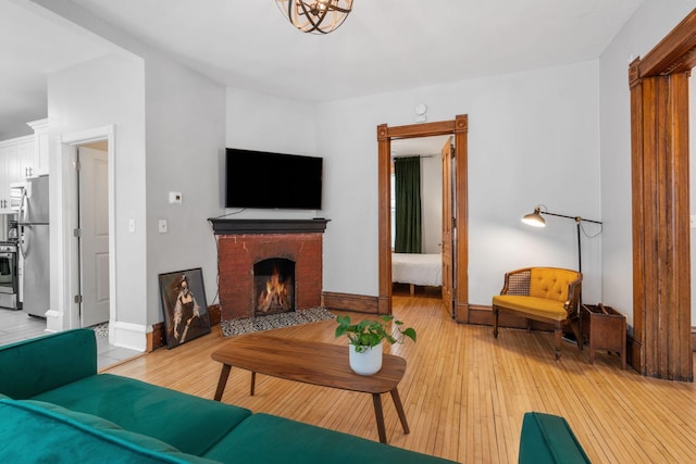 living room with a fireplace and light hardwood / wood-style flooring