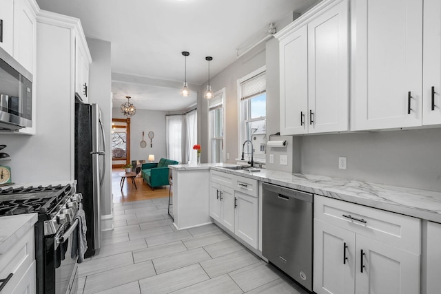 kitchen with appliances with stainless steel finishes, white cabinets, and sink