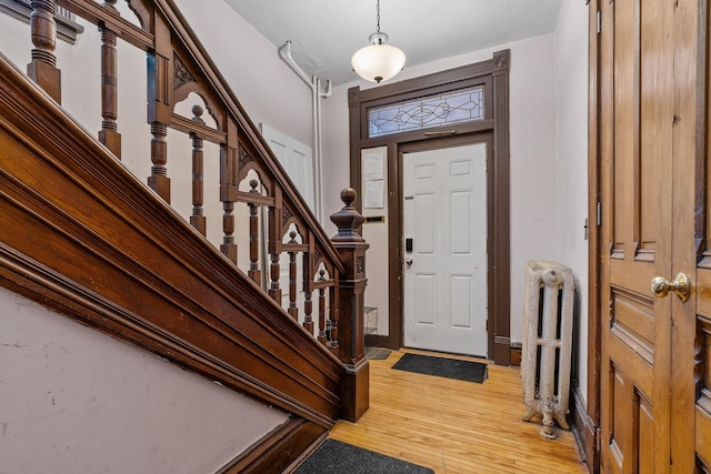 entrance foyer featuring hardwood / wood-style flooring and radiator heating unit