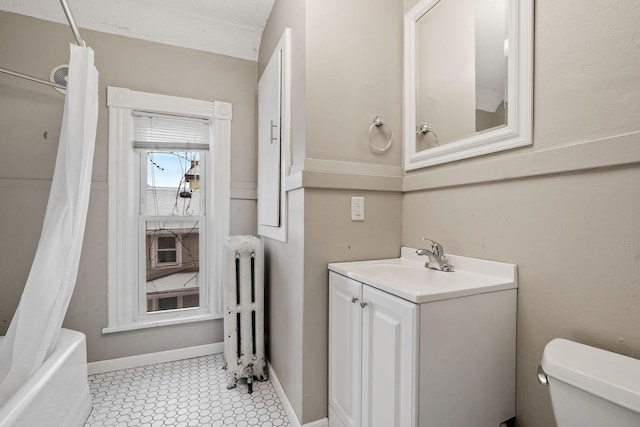 full bathroom featuring a textured ceiling, radiator, vanity, toilet, and shower / bath combo