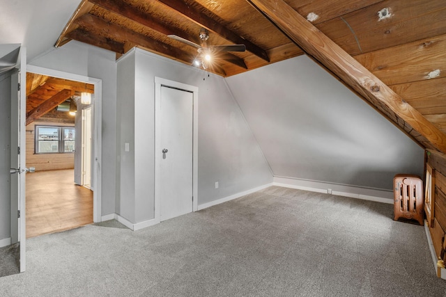 bonus room with wooden ceiling, vaulted ceiling with beams, radiator heating unit, and carpet flooring