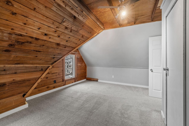 additional living space with carpet floors, wood ceiling, wood walls, and lofted ceiling