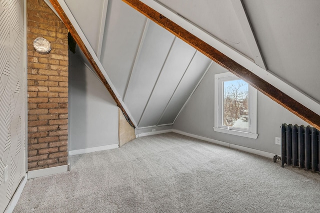 additional living space with lofted ceiling, radiator heating unit, and light carpet