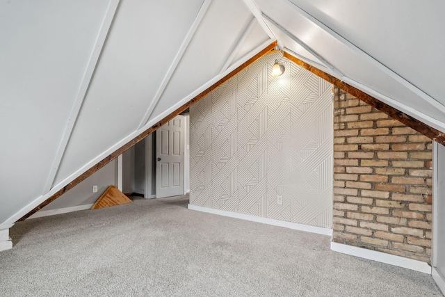 bonus room with vaulted ceiling and carpet flooring