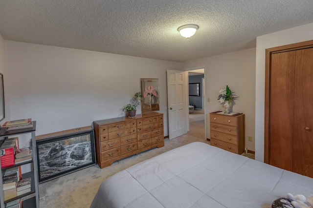 carpeted bedroom featuring a textured ceiling and a closet