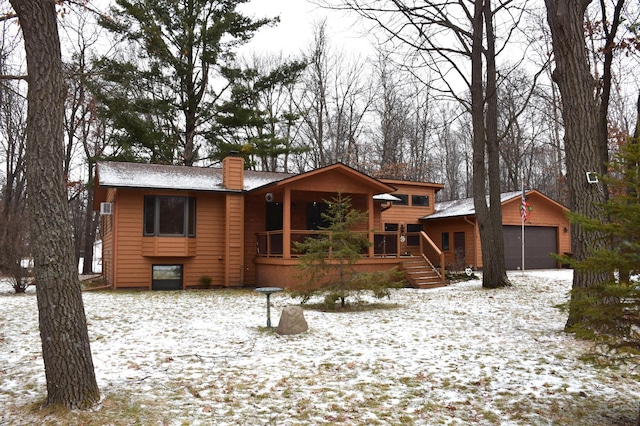 view of front facade featuring a garage and an outbuilding