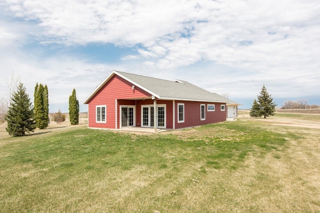 rear view of property featuring a yard and a patio