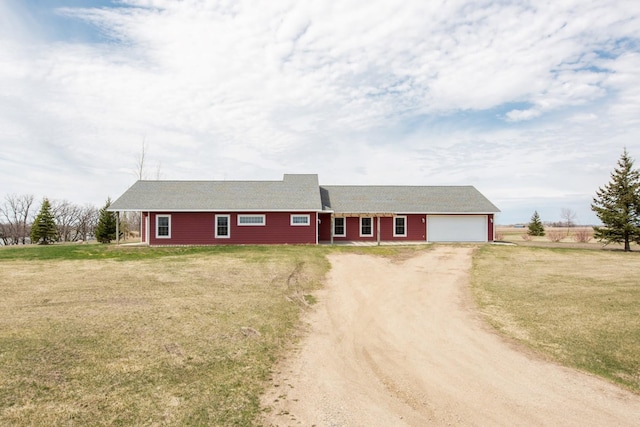 single story home with a garage and a front lawn