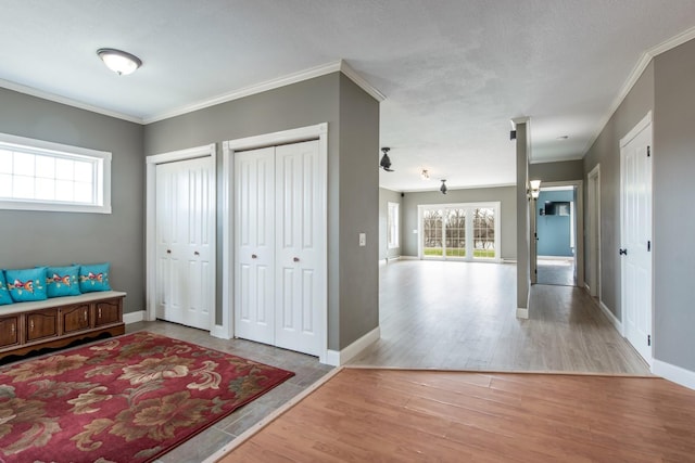 interior space featuring crown molding and light hardwood / wood-style floors