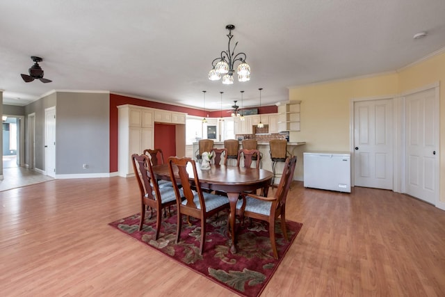 dining space featuring ornamental molding, ceiling fan, and light hardwood / wood-style flooring