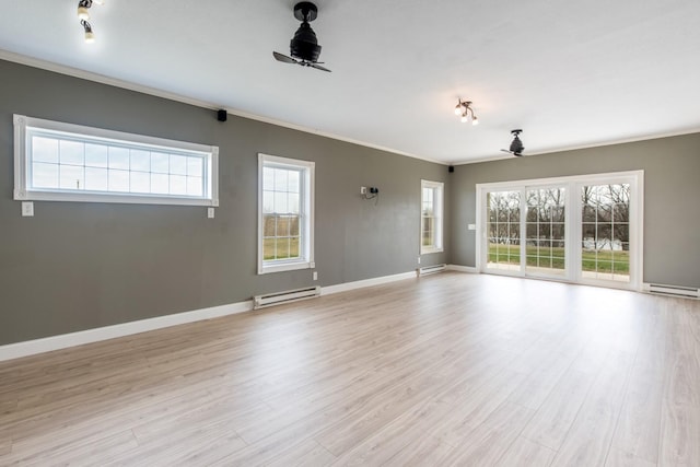 empty room with ceiling fan, ornamental molding, baseboard heating, and light hardwood / wood-style floors