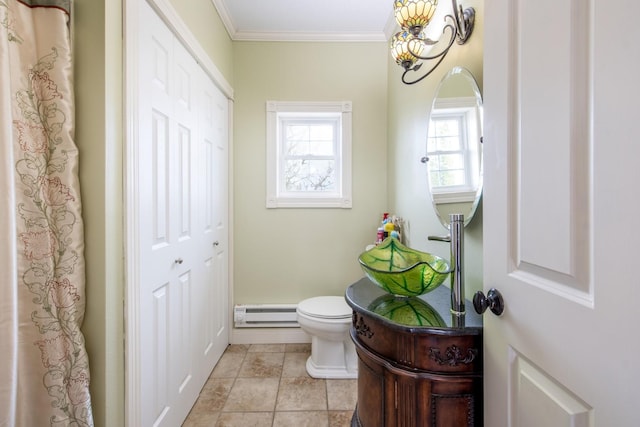 bathroom with sink, crown molding, a baseboard radiator, and toilet