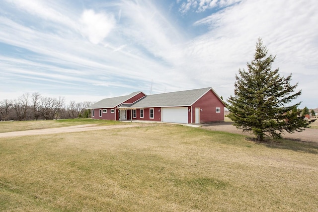 ranch-style home featuring a garage and a front lawn