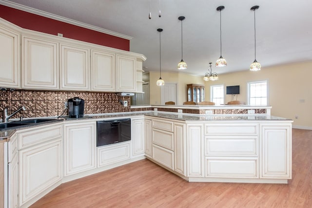 kitchen with pendant lighting, kitchen peninsula, sink, and light hardwood / wood-style flooring