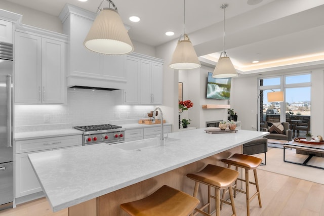 1 Hill Farm Rd Unit 107, North Oaks, MN 55127 - kitchen with white cabinets, a sink, light wood finished floors, and tasteful backsplash