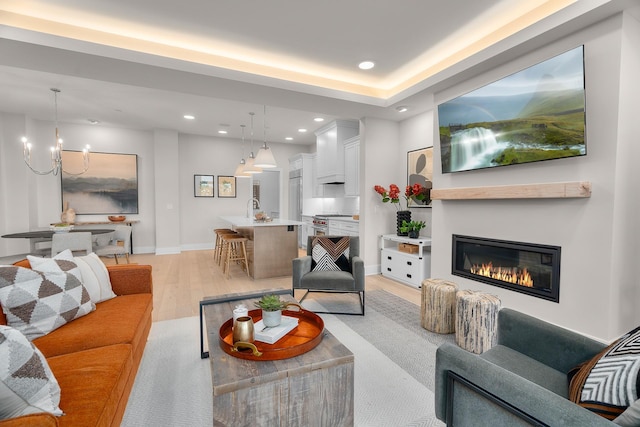 1 Hill Farm Rd Unit 107, North Oaks, MN 55127 - living room with an inviting chandelier, a glass covered fireplace, light wood-style flooring, recessed lighting, and baseboards