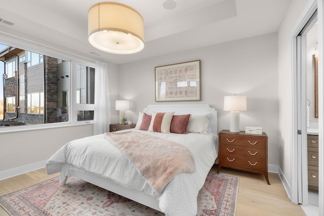 1 Hill Farm Rd Unit 107, North Oaks, MN 55127 - bedroom with baseboards, light wood finished floors, and visible vents
